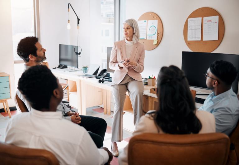 Any questions. Shot of a mature therapists sitting and training her team in the office.